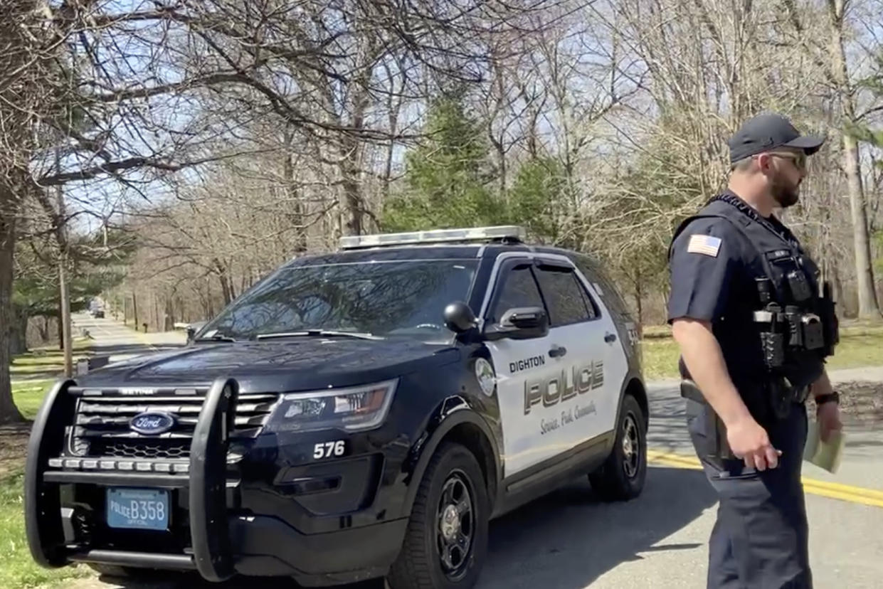 In this image taken from video, police block a road in North Dighton, Mass., Thursday, April 13, 2023. The FBI wants to question a 21-year-old member of the Massachusetts Air National Guard in connection with the disclosure of highly classified military documents on the Ukraine war, two people familiar with the investigation said. (AP Photo/Michelle R. Smith)