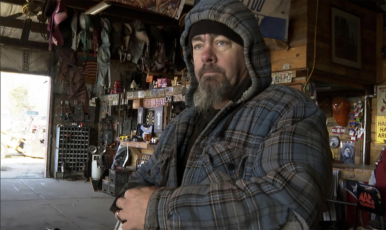 David Hollon stands inside his garage in Autauga County, Ala., on Saturday, Jan. 14, 2023. The Alabama engine mechanic took refuge in a shipping container near the back of his garage as a tornado from Thursday's violent storm decimated his shop and killed two of his neighbors along its destructive path across Alabama and Georgia. (AP Photo/Sharon Johnson)