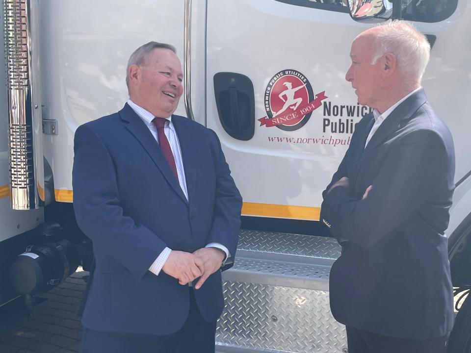 Norwich Public Utilities General Manager Chris LaRose talks with U.S. Rep. Joe Courtney in front of an NPU truck Wednesday. This was after the utility accepted $10 million in federal funding to replace natural gas pipes throughout Norwich.