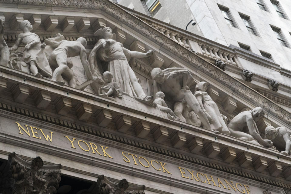 FILE - Stone sculptures adorn the New York Stock Exchange, Thursday, Nov. 5, 2020, in New York. Stocks are opening lower on Wall Street, Thursday, Nov. 19, as mounting coronavirus infections and evidence of the damage being cause to people's livelihoods rolls in. (AP Photo/Mark Lennihan, File)