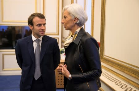FILE PHOTO: Lagarde speaks with Macron during a meeting with international economic organisations at the OECD in Paris