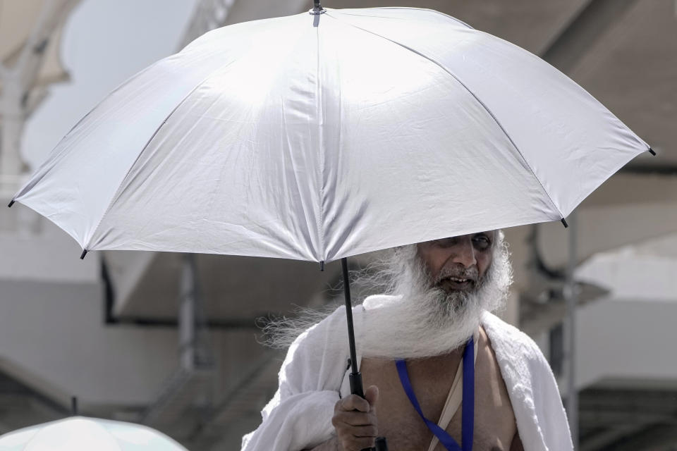 An Indian pilgrim holds his umbrella at the Mina tent camp, in Mecca, Saudi Arabia, during the annual hajj pilgrimage, Monday, June 26, 2023. Muslim pilgrims are converging on Saudi Arabia's holy city of Mecca for the largest hajj since the coronavirus pandemic severely curtailed access to one of Islam's five pillars. (AP Photo/Amr Nabil)