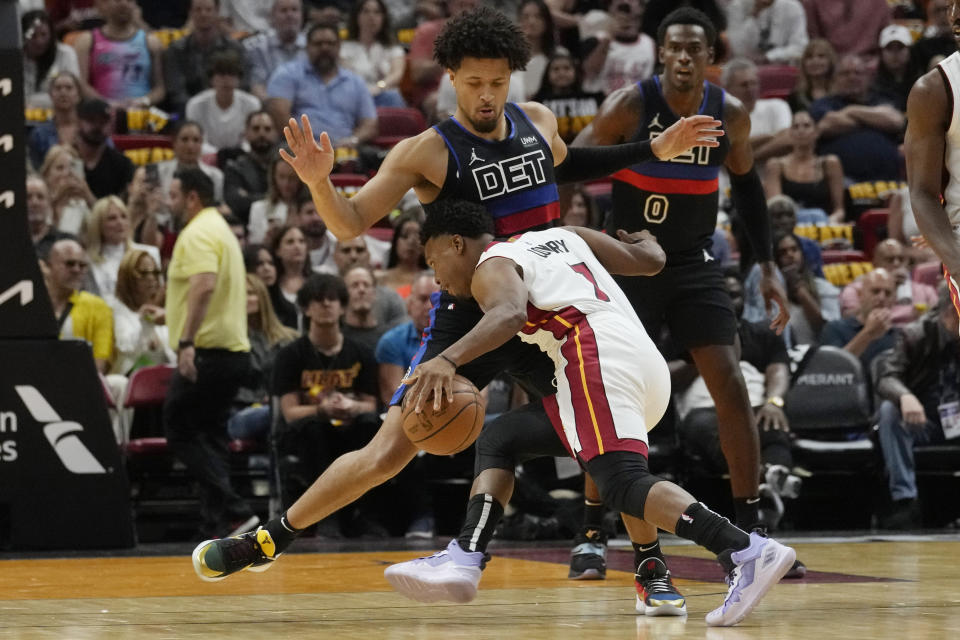Detroit Pistons guard Cade Cunningham (2) stops Miami Heat guard Kyle Lowry (7) during the first half of an NBA basketball game, Wednesday, Oct. 25, 2023, in Miami. (AP Photo/Marta Lavandier)