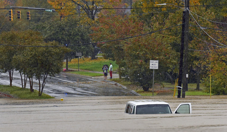 A vehicle is submerged in floodwater on Freedom Drive in Charlotte, N.C., Thursday, Nov. 12, 2020. Tropical Storm Eta dumped blustery rain across north Florida after landfall Thursday morning north of the heavily populated Tampa Bay area, and then sped out into the Atlantic off of the neighboring coasts of Georgia and the Carolinas. (Jeff Siner/The Charlotte Observer via AP)