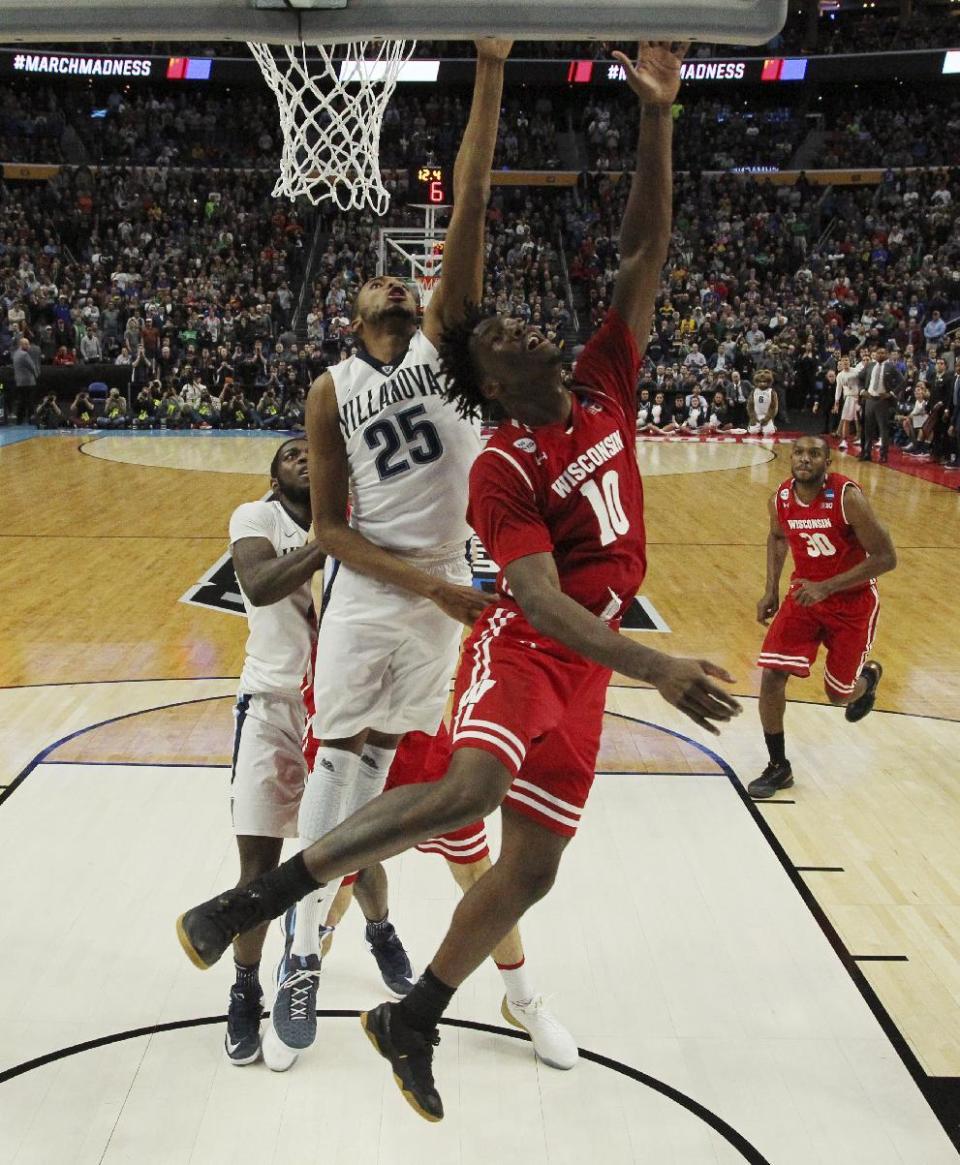 Wisconsin forward Nigel Hayes (10) scores the game-winning basket against Villanova guard Mikal Bridges (25) with 11 seconds to play in the second half of a second-round men's college basketball game in the NCAA Tournament, Saturday, March 18, 2017, in Buffalo, N.Y. Wisconsin won, 65-62. (AP Photo/Bill Wippert)