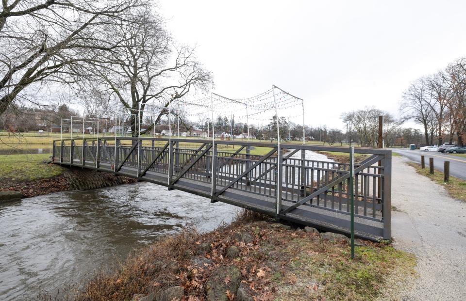 A lighted tunnel above the bridge over the West Branch of the Nimishillen Creek in Stadium Park was rebuilt after being damaged by vandals earlier this month.