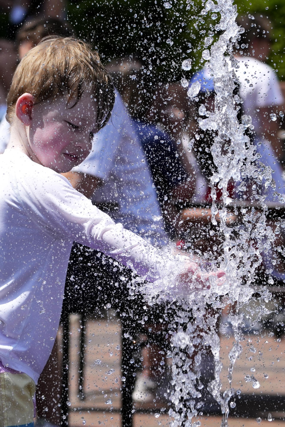 A boy cools off at a fountain during hot weather in Chicago, Sunday, June 16, 2024. (AP Photo/Nam Y. Huh)