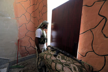 A members of the Syrian Democratic Forces keeps guard at their position, during the fighting with Islamic State's fighters in Nazlat Shahada, a district of Raqqa, Syria August 16, 2017. REUTERS/Zohra Bensemra