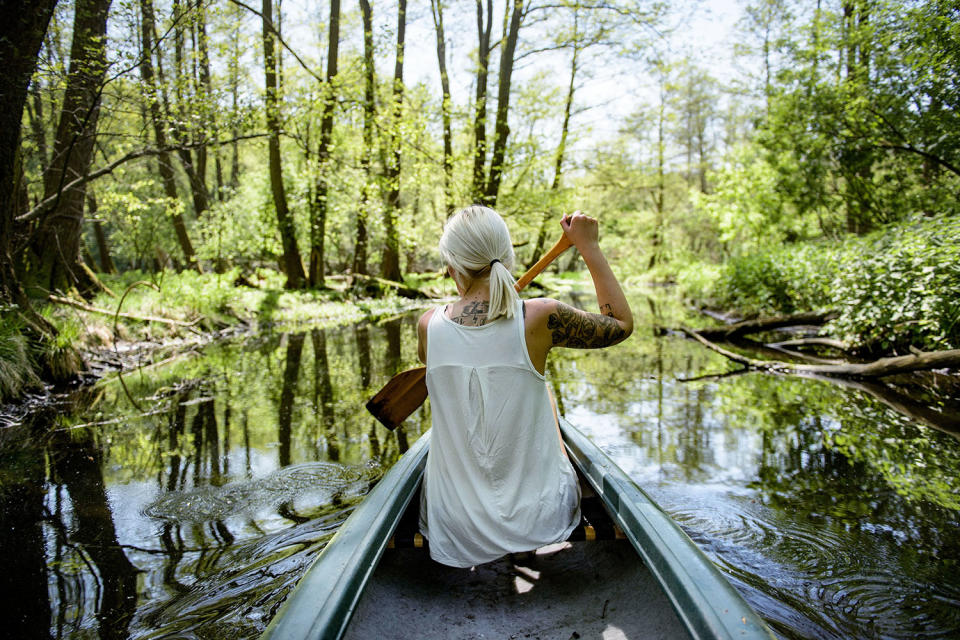 <p>A young woman paddles a canoe on the creek ‘Loecknitz’ in Brandenburg state on May 19, 2017 near Erkner, Germany. Brandenburg, with its multitude of waterways and lakes that are rich in plant and wildlife, is a popular destination for canoeing and other water sports enthusiasts. (Photo: Thomas Lohnes/Getty Images) </p>