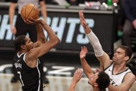 Brooklyn Nets forward Kevin Durant (7) shoots over Milwaukee Bucks center Brook Lopez during the first half of an NBA basketball game Monday, Jan. 18, 2021, in New York. (AP Photo/Adam Hunger)