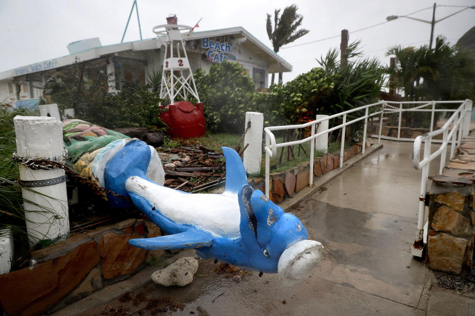 A dolphin statue at Anglin's Fishing Pier lies toppled by Hurricane Irma.