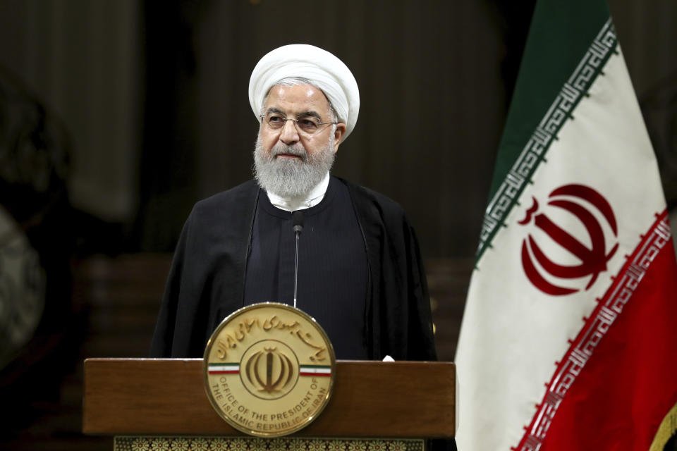 Iranian President Hassan Rouhani listens during a joint press conference with Japanese Prime Minister Shinzo Abe, after their meeting at the Saadabad Palace in Tehran, Iran, Wednesday, June 12, 2019. The Japanese leader is in Tehran on an mission to calm tensions between the U.S. and Iran. (AP Photo/Ebrahim Noroozi)