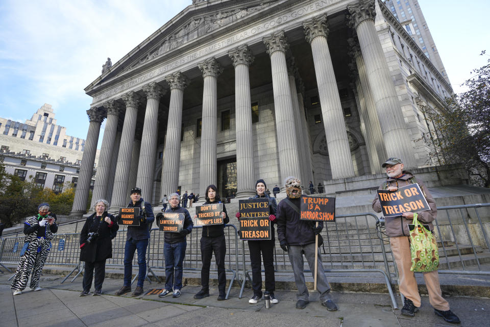 Halloween-themed protesters stand in front of New York Supreme Court, where former President Donald Trump is facing fraud charges, Tuesday, Oct. 31, 2023, in New York. (AP Photo/Seth Wenig)