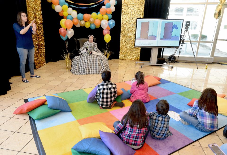 Mary Todd Lincoln impersonator Pam Brown of Springfield, top center, reads a children's book at the  Abraham Lincoln Presidential Library and Museum Saturday Feb. 11, 2023 as part of a read-a-thon at the museum to celebrate Lincoln's birthday.