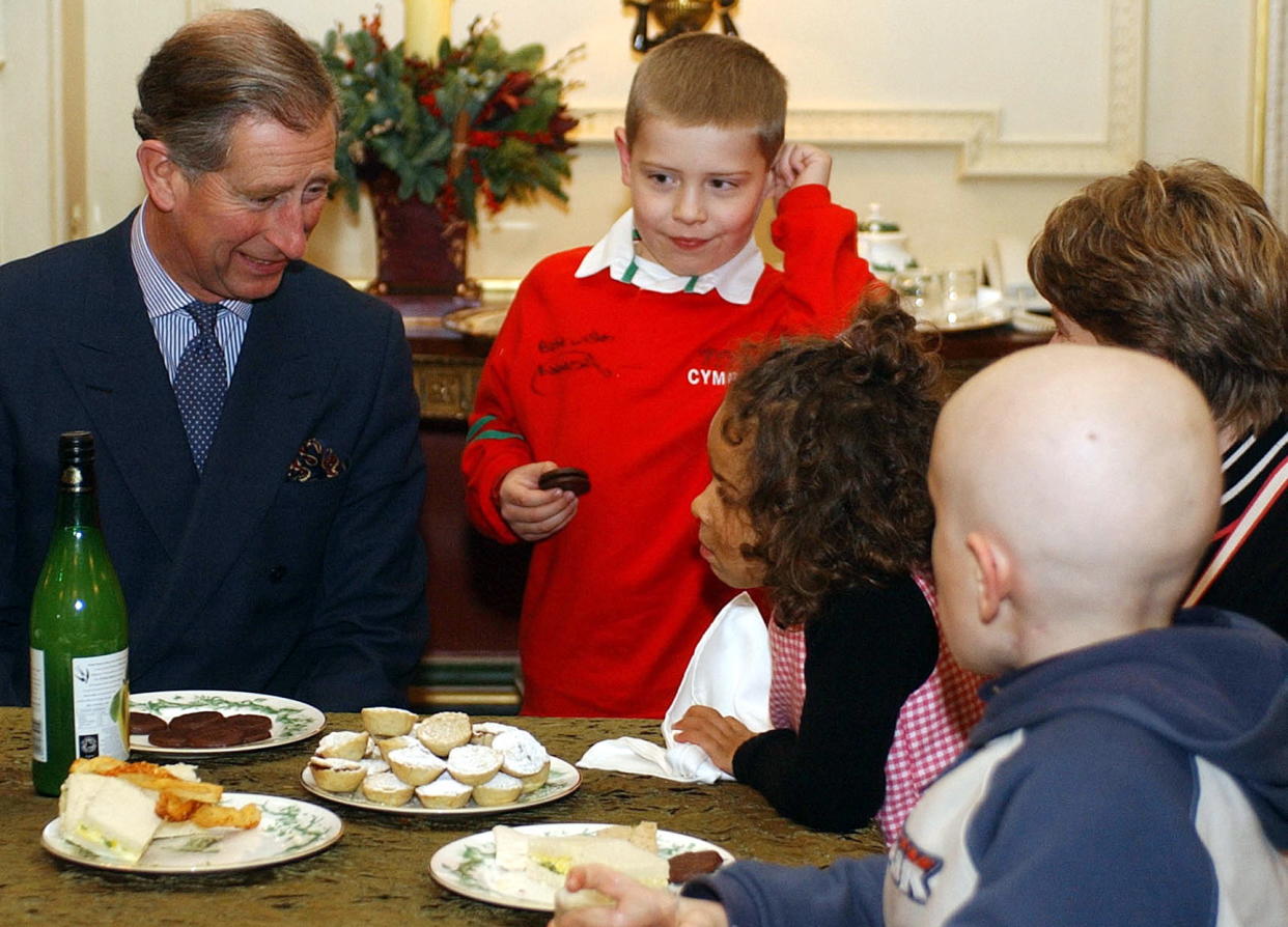 Prince Charles Eating Chocolate Biscuits And Mince Pies With Eight Year Old Jack Seymour, In The Red Top, And Other Children,  At A Reception For Ill Children Held At Clarence House. On The Table Are Duchy Of Cornwall Products.  (Getty Images)