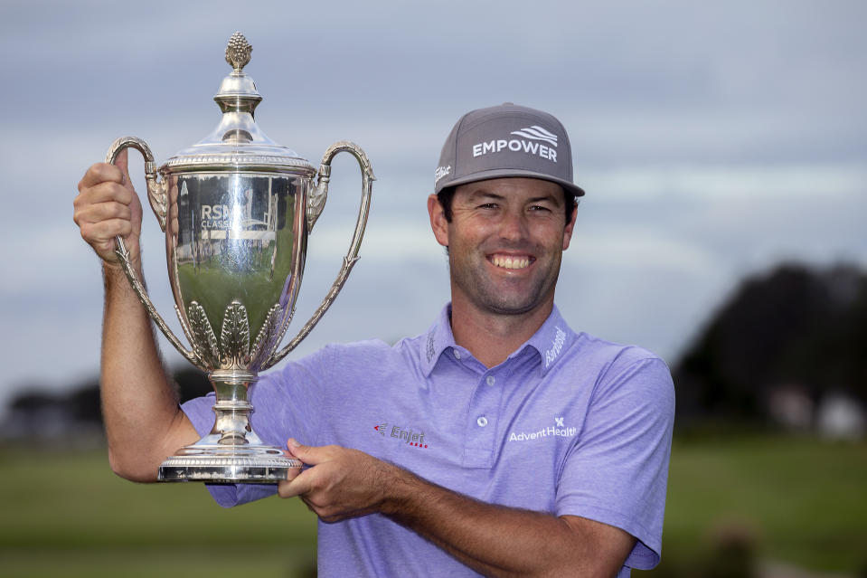 Robert Streb holds the trophy after winning a second hole playoff against Kevin Kisner at the RSM Classic golf tournament, Sunday, Nov. 22, 2020, in St. Simons Island, Ga. (AP Photo/Stephen B. Morton)