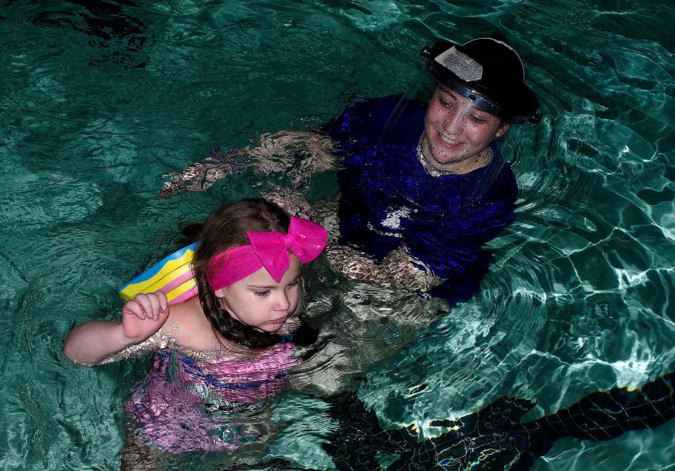 Maggie Mendonca, 6, of East Bridgewater, goes through her swimming and water safety class at the YMCA in Middleboro with Y instructor Olivia Pasquarello on Sunday, Jan. 20, 2022.