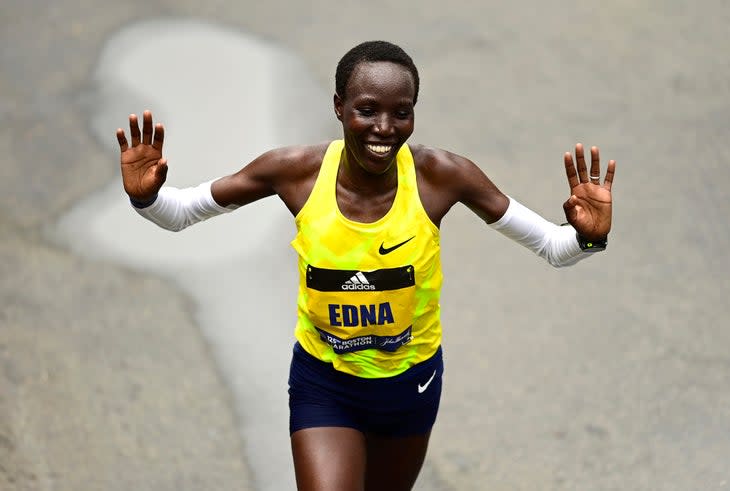 Edna Kiplagat finishing the 2021 Boston Marathon, hands raised