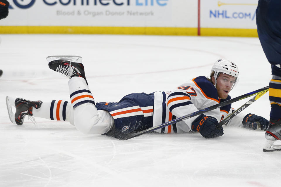 Edmonton Oilers forward Connor McDavid (97) is tripped during the second period of an NHL hockey game against the Buffalo Sabres, Thursday, Jan. 2, 2020, in Buffalo, N.Y. (AP Photo/Jeffrey T. Barnes)