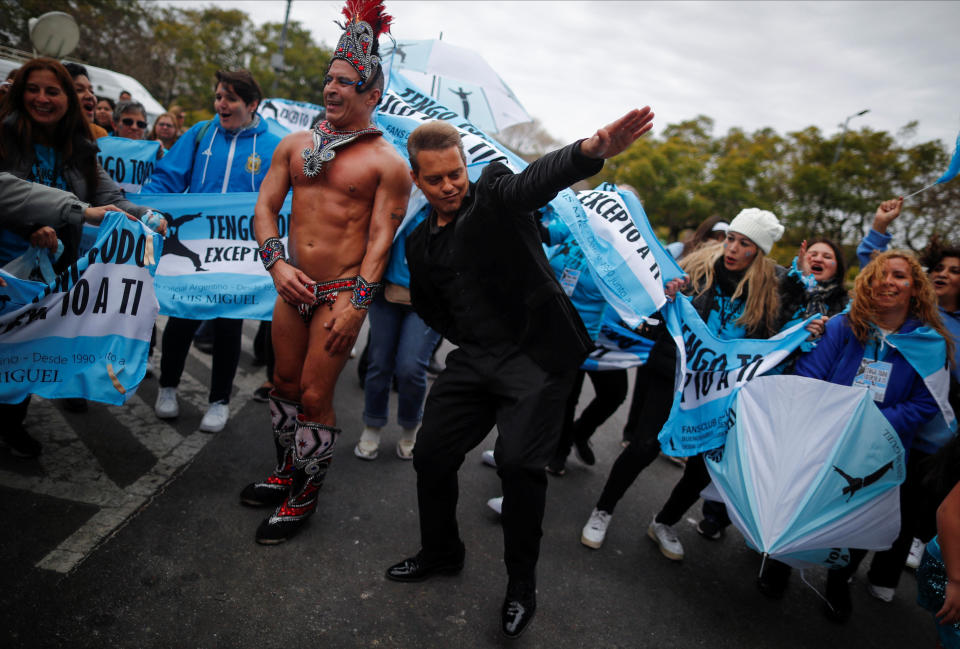 Argentine impersonator of Mexican singer Luis Miguel, Guillermo Elias, 50, dances with members of Miguel's fan club and a batucada group before leaving in a joy train (a modified bus) to the stadium where the singer will perform tonight, in Buenos Aires, Argentina August 3, 2023. REUTERS/Agustin Marcarian