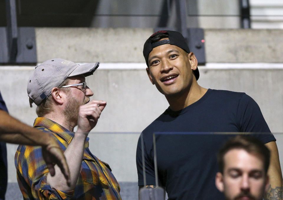 Israel Folau, right, in the stands during the Netball World Cup match between Australia and New Zealand in Liverpool, England, Thursday July 18, 2019. (Nigel French/PA via AP)