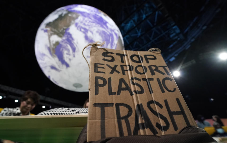 A sign sticks out of a activists backpack inside the venue of the COP26 U.N. Climate Summit in Glasgow, Scotland, Tuesday, Nov. 9, 2021. The U.N. climate summit in Glasgow has entered it's second week as leaders from around the world, are gathering in Scotland's biggest city, to lay out their vision for addressing the common challenge of global warming. (AP Photo/Alberto Pezzali)