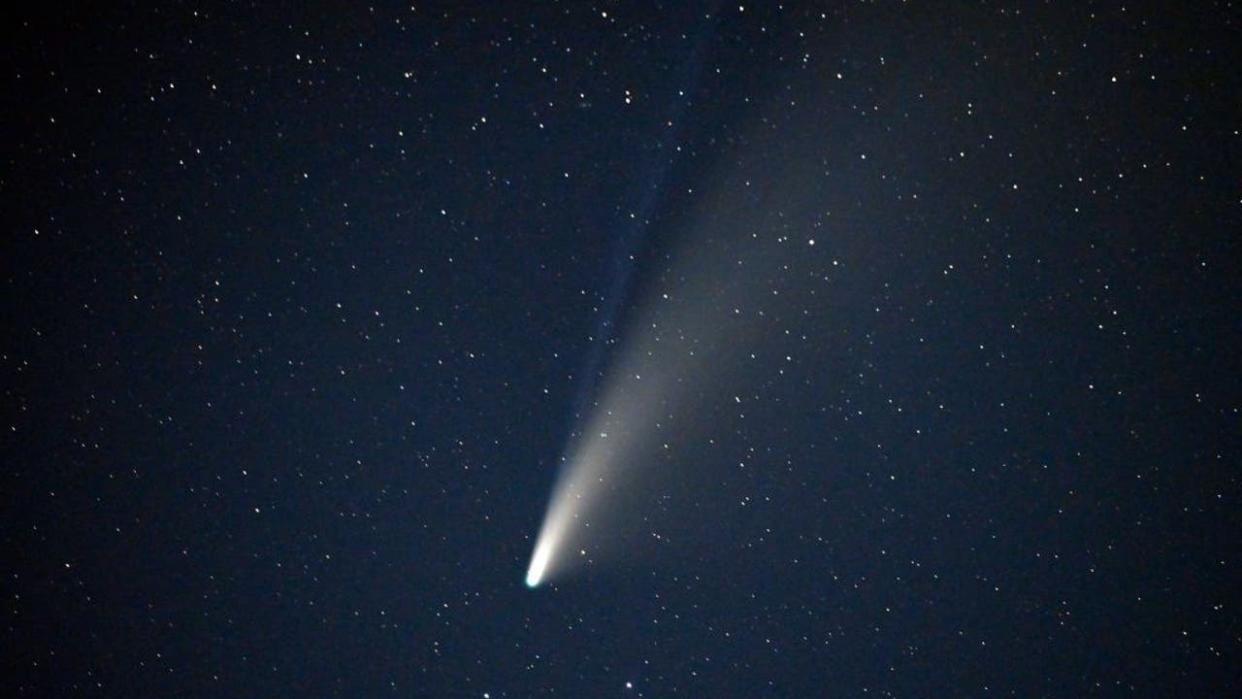 <div>TOPSHOT - The Comet NEOWISE or C/2020 F3, with its two tails visible, is seen in the sky above Goldfield, Nevada on July 18, 2020. The Comet C/2020 F3 was discovered March 27, 2020, by NEOWISE, the Near Earth Object Wide-field Infrared Survey Explorer, which is a space telescope launched by NASA in 2009. (Photo by David Becker / AFP) (Photo by DAVID BECKER/AFP via Getty Images)</div>