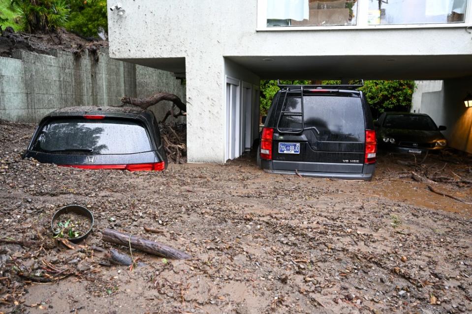 A view of vehicles were buried in mudslides at Beverly Crest neighborhood, as atmospheric river storms hit Los Angeles, California. Anadolu via Getty Images