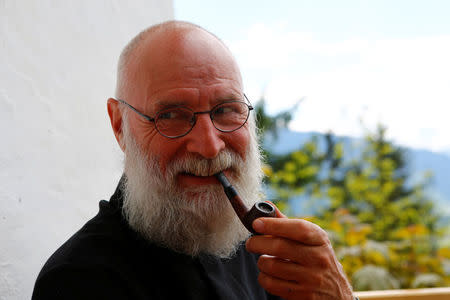 Hermit Stan Vanuytrecht of Belgium smokes a pipe outside his hermitage in Saalfelden, Austria, May 22, 2017. Picture taken May 22, 2017. REUTERS/Leonhard Foeger