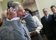 Britain's Prince Charles listens to a talking point project during a visit to the East Belfast Community Development Agency in Belfast, Northern Ireland May 21, 2015. REUTERS/Darren Staples