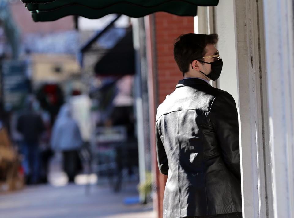 A young man enters Starbucks in Market Square in Portsmouth wearing his mask on Monday afternoon.