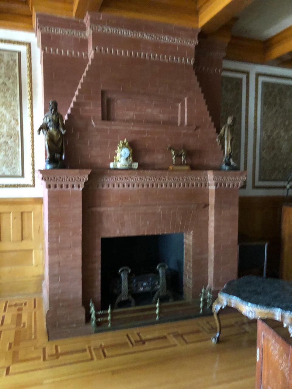 Upon entering the front door of the Bivins Home, a fireplace with inlaid wood stands to the south.