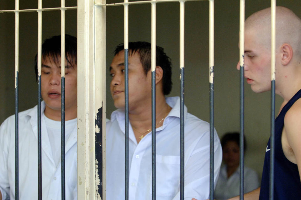 A 2006 file image of (L-R) Si Yi Chen, Tan Duc Thanh Nguyen and Matthew Norman talking to their lawyer at a holding cell at Denpasar Court before they were sentenced to life for heroin trafficking in Denpasar, Bali. Source: AAP/Mick Tsikas