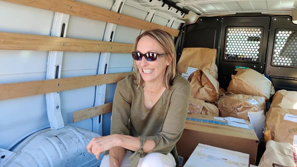 Chelsea Sutula, chief executive officer of Sespe Creek Collective in Ojai, sits in the back of a van carrying bags of cannabis returned this week.
