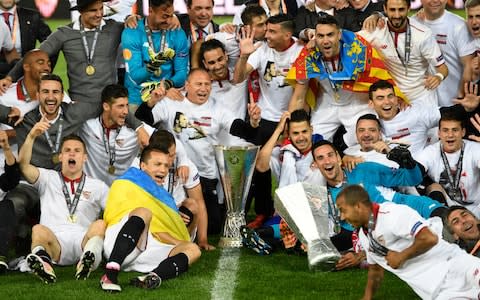 Sevilla celebrate with Europa League trophy - Credit: EPA