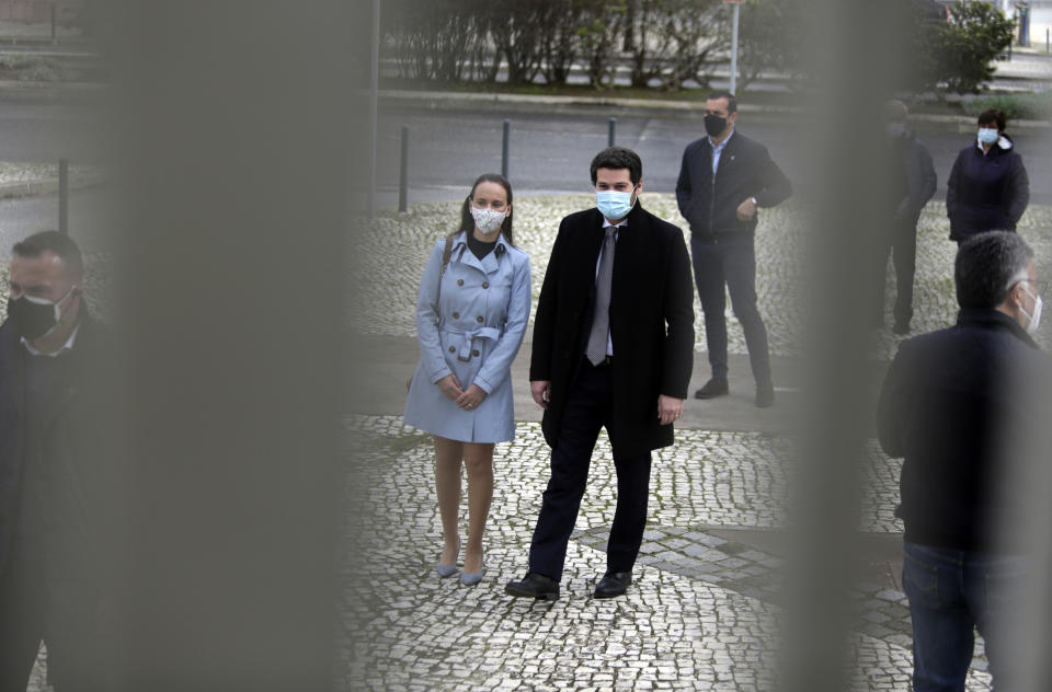 Right-wing populist presidential candidate Andre Ventura, center, queues to vote outside a polling station in Lisbon, Sunday, Jan. 24, 2021. Portugal holds a presidential election Sunday, choosing a head of state to serve a five-year term. (AP Photo/Armando Franca)