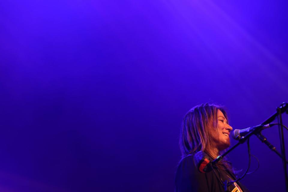 A female rock singer performs onstage