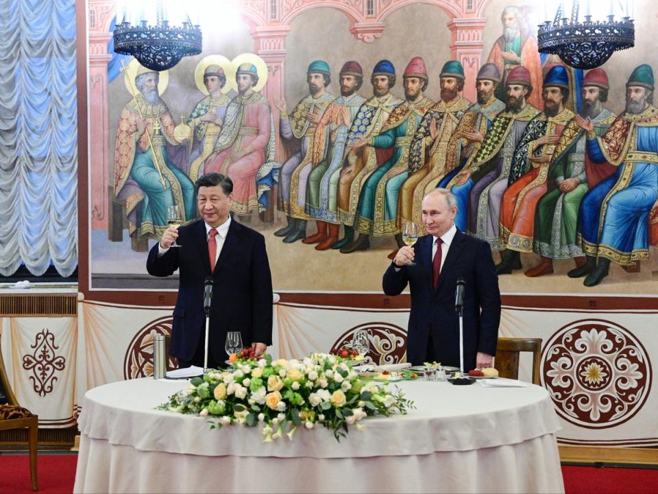 Russian president Vladimir Putin and China's President Xi Jinping hold glasses during a reception following their talks at the Kremlin in Moscow on 21 March 2023 (SPUTNIK/AFP via Getty Images)