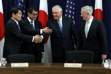 (L-R) Japan's Defense Minister Itsunori Onodera and Foreign Minister Taro Kono shake hands with U.S. Secretary of State Rex Tillerson and Defense Secretary James Mattis before sitting down for U.S.-Japan Security talks at the State Department in Washington, U.S. August 17, 2017. REUTERS/Jonathan Ernst