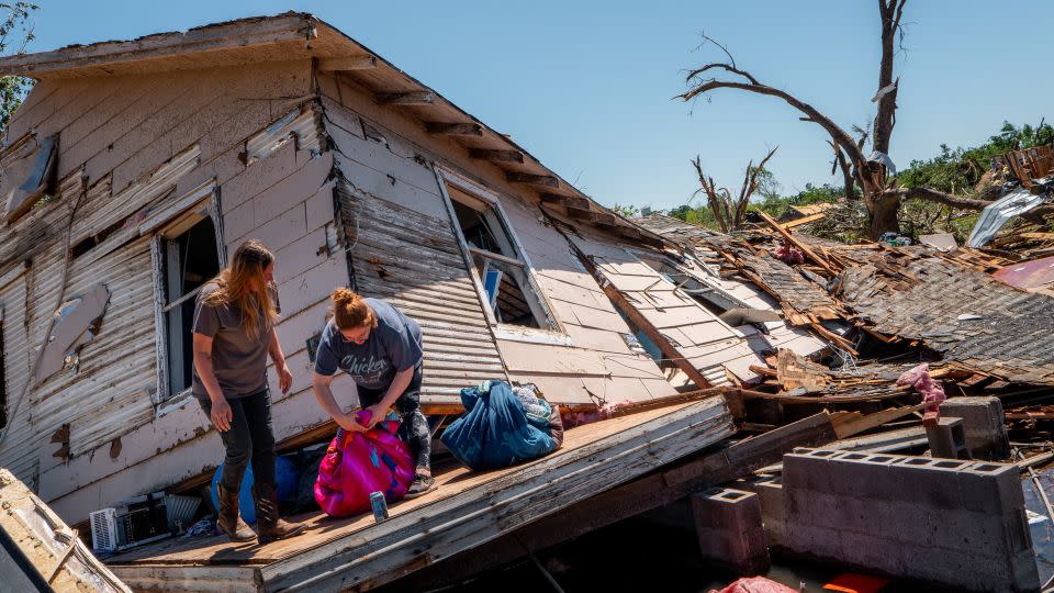 The Crowder family sift through and recover lost items after their home was struck by a tornado on May 07, 2024 in Barnsdall, Oklahoma. - Brandon Bell/Getty Images