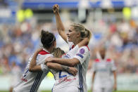 FILE - In this Sunday, April 21, 2019 file photo, Lyon's Delphine Cascarino, center, celebrates with Ada Hegerberg, right, and Lucy Bronze after scoring against Chelsea during the Women's Champions League semifinal soccer match in Decines, France. UEFA launched its five-year development plan for women’s soccer Friday May 17, 2019, in a breakthrough season leading to the World Cup in France. The strategy document, Time for Action, sets out how the European soccer body aims to double the number of women and girls playing, and change perceptions of their game. (AP Photo/Laurent Cipriani, File)