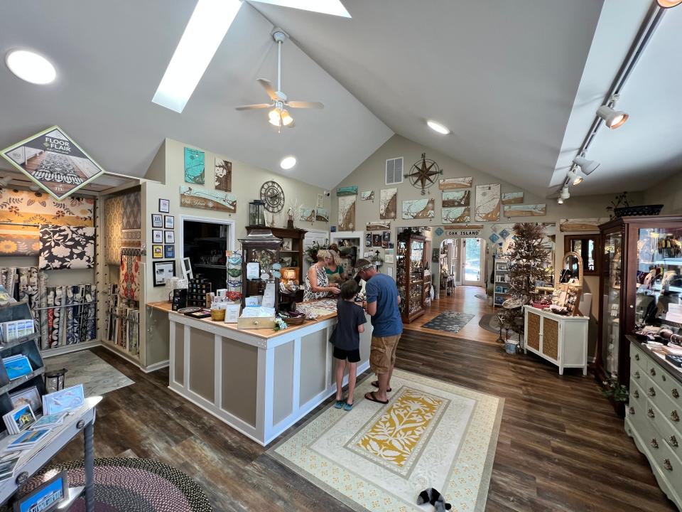 On Thursday, July 28, shoppers make their purchases at Cattail Cottage, a home decor shop located in downtown Southport.