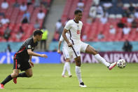 England's Jude Bellingham, right, plays the ball during the Euro 2020 soccer championship group D match between England and Croatia at Wembley stadium in London, Sunday, June 13, 2021. (Glyn Kirk/Pool Photo via AP)