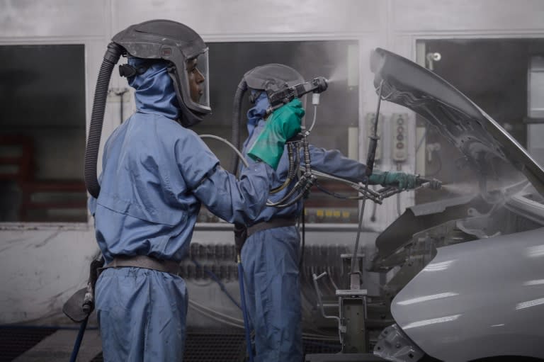 Workers paint cars on the assembly line at Nissan's factory in Resende, Brazil, on Februrary 3, 2015