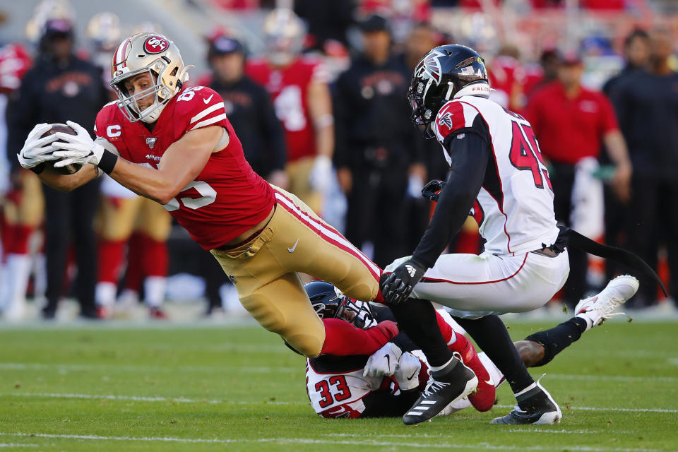 FILE - In this Dec. 15, 2019, file photo, San Francisco 49ers tight end George Kittle, left, runs against Atlanta Falcons defensive back Blidi Wreh-Wilson (33) and linebacker Deion Jones (45) during the first half of an NFL football game in Santa Clara, Calif. Kittle has agreed to a five-year extension with the San Francisco 49ers that reportedly is the richest contract ever at the position. A person familiar with the deal says the sides agreed Thursday, Aug. 13, 2020, on the deal to keep Kittle off the market next offseason. (AP Photo/John Hefti, File)