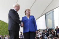 German Chancellor Angela Merkel welcomes Britain's Prime Minister Boris Johnson for a meeting at the Chancellery in Berlin, Germany, Wednesday, Aug. 21, 2019. (AP Photo/Michael Sohn)
