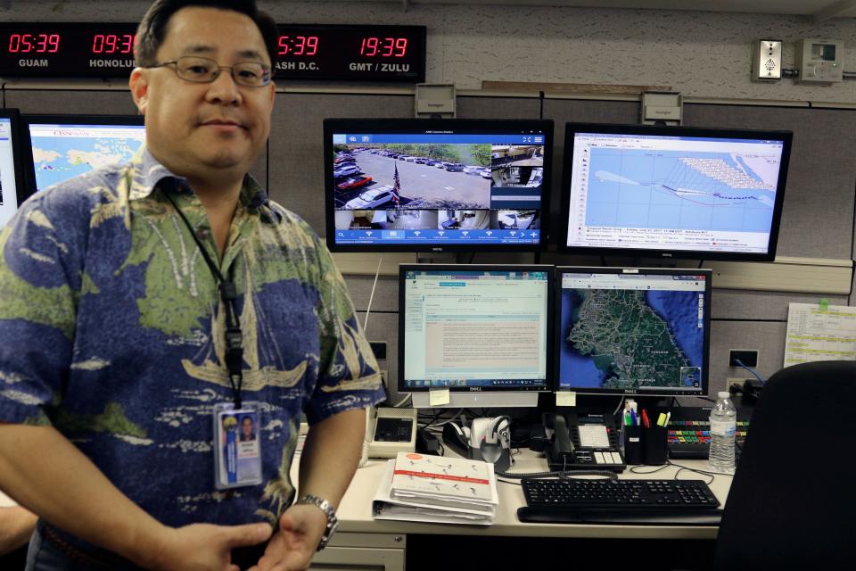 Jeffrey Wong, the Hawaii Emergency Management Agency's current operations officer, shows computer screens monitoring hazard - Credit: Jennifer Sinco/AP
