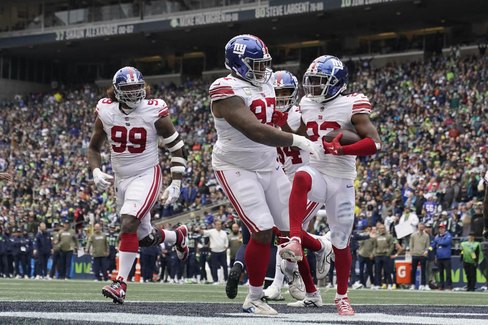 New York Giants cornerback Adoree' Jackson, right, celebrates with defensive tackle Dexter Lawrence after recovering a fumble against the Seattle Seahawks during the first half of an NFL football game in Seattle, Sunday, Oct. 30, 2022. (AP Photo/Marcio Jose Sanchez)