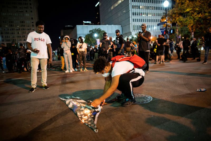 FILE PHOTO: Demonstrators wait for the start of the curfew at Jefferson Square after a grand jury decided not to bring homicide charges against police officers involved in the fatal shooting of Breonna Taylor, in Louisville
