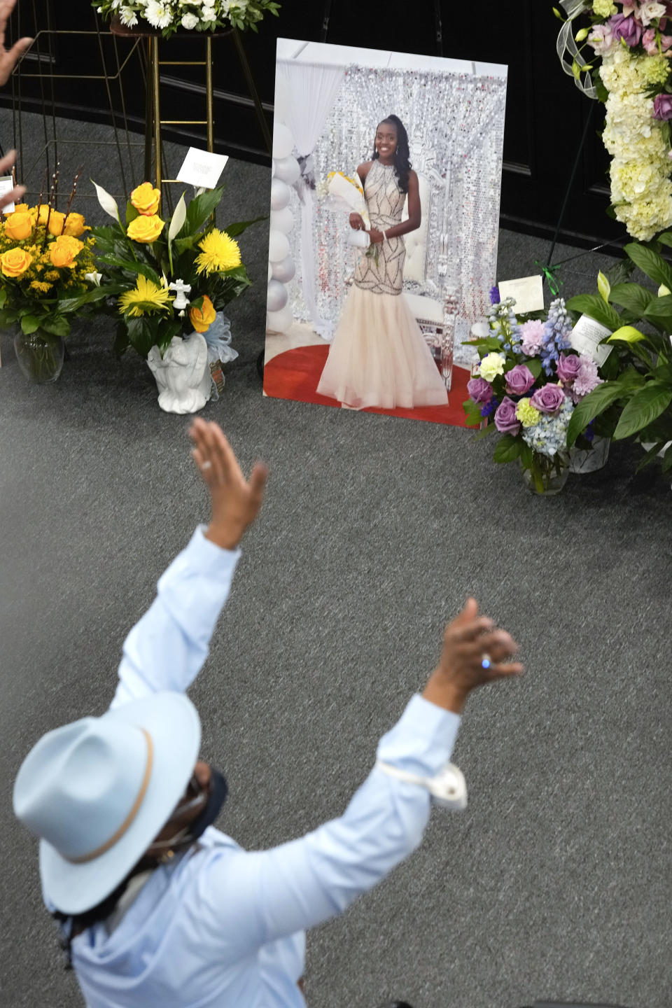 A mourner attends the funeral for Michigan State University shooting victim Arielle Anderson, in photo, in Detroit, Tuesday, Feb. 21, 2023. Anderson, Alexandria Verner and Brian Fraser and were killed and several other students injured after a gunman opened fire on the campus of Michigan State University. (AP Photo/Paul Sancya)